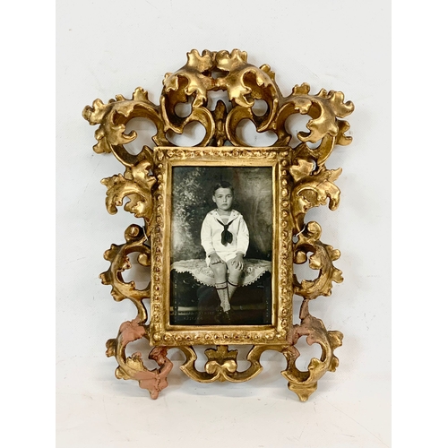 213 - A late Victorian ornate gilt frame. 24 x 30cm