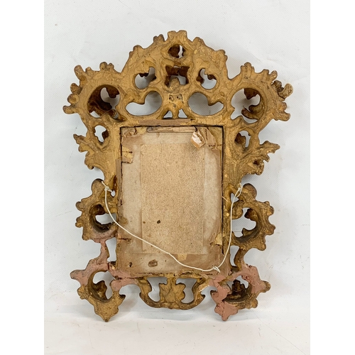 213 - A late Victorian ornate gilt frame. 24 x 30cm