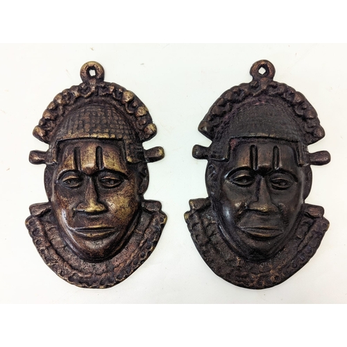 217 - A pair of Benin bronze Oba face mask plaques. 18x29cm