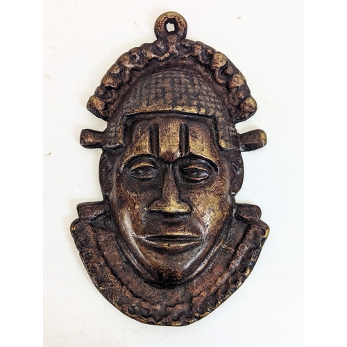 217 - A pair of Benin bronze Oba face mask plaques. 18x29cm