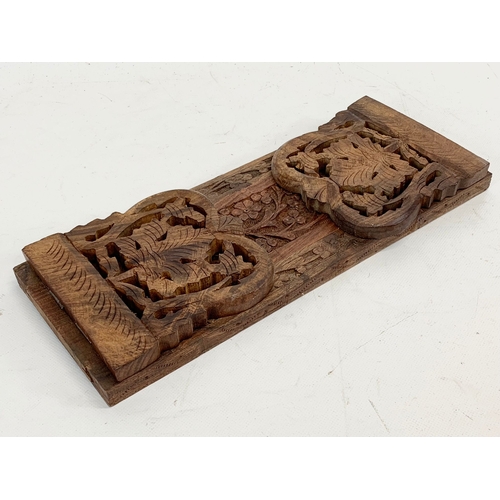 221 - A carved sliding book shelf.