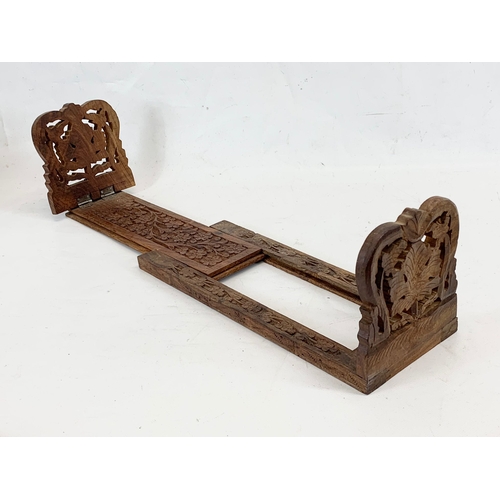 221 - A carved sliding book shelf.