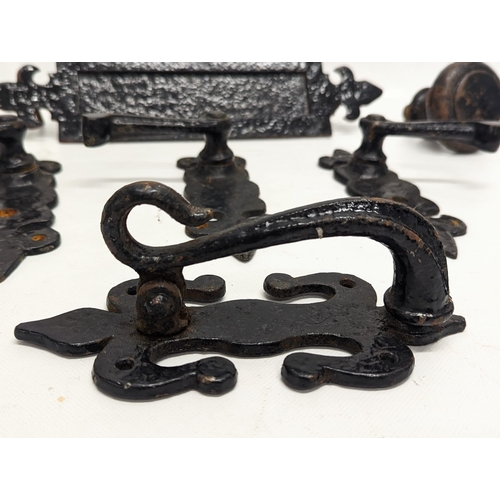 225 - A quantity of early 20th century cast iron door furniture.