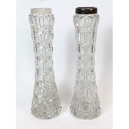 563 - A pair of silver topped cut crystal vases. 18cm