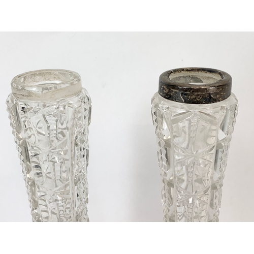 563 - A pair of silver topped cut crystal vases. 18cm