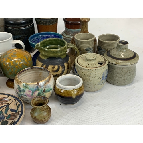 573 - A large collection of mostly signed Studio Pottery.