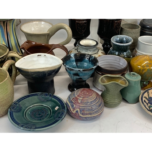 573 - A large collection of mostly signed Studio Pottery.