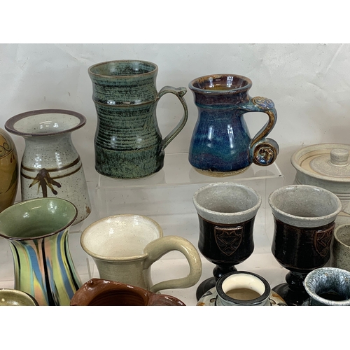 573 - A large collection of mostly signed Studio Pottery.