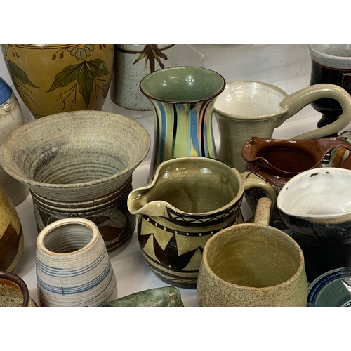 573 - A large collection of mostly signed Studio Pottery.