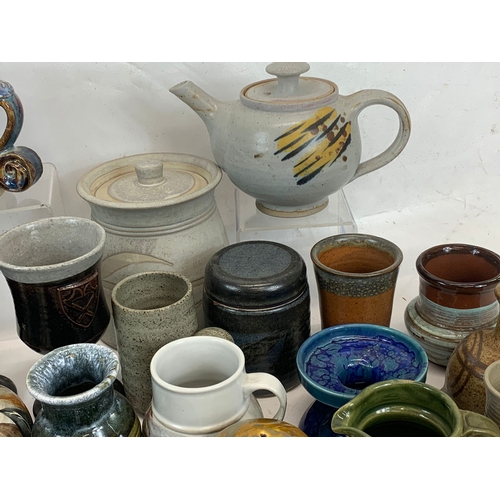 573 - A large collection of mostly signed Studio Pottery.