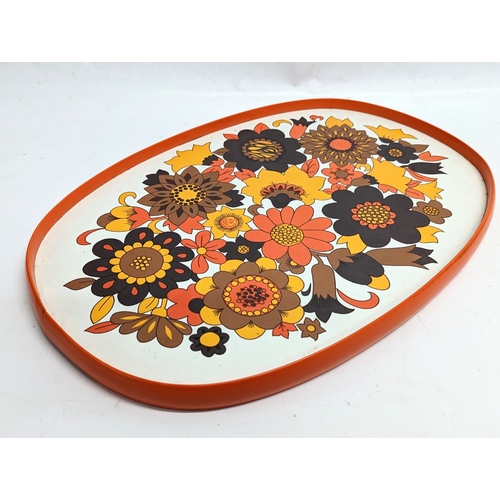 307 - 2 Mid Century serving trays. 1 by St. Michael, and 1 by Thetford. Largest measures 55x39cm