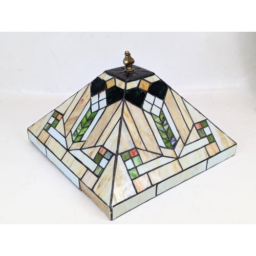 321 - A Tiffany style lamp. The shade measures 36x24cm.