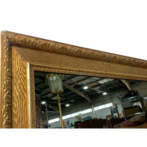 298 - An ornate gilt framed mirror. 73 x 92cm