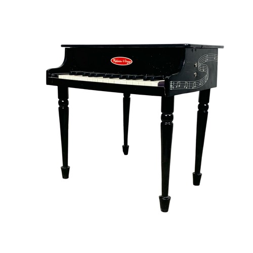 270 - A miniature Melissa & Doug grand piano and stool. 50.5 x 55 x 50cm