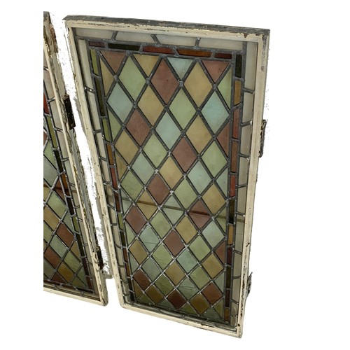 320 - A pair of Victorian stained glass panels in brass frames. 38 x 92cm