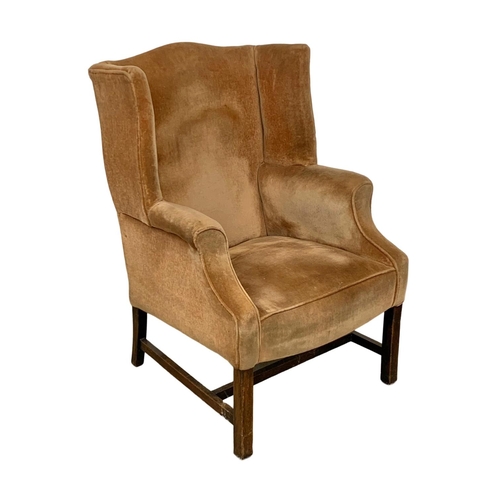 1129 - A vintage Georgian style wingback armchair.