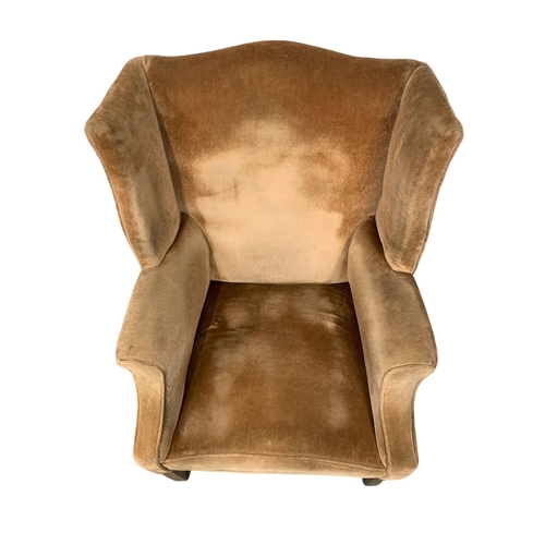 1129 - A vintage Georgian style wingback armchair.