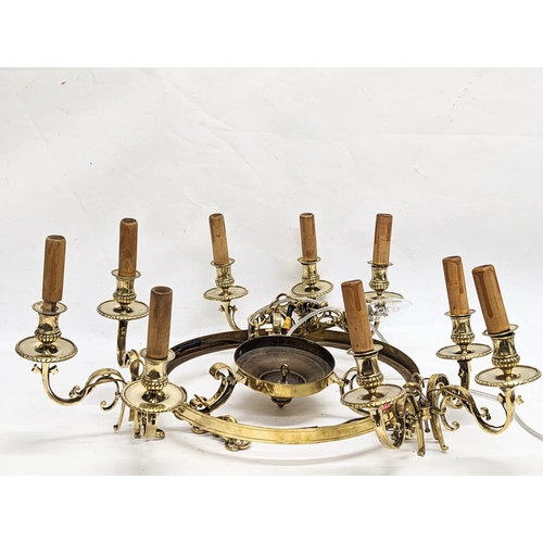 362 - A large brass chandelier with glass shade. 55cm