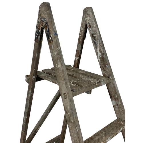 377 - A vintage wooden step ladder. 196cm