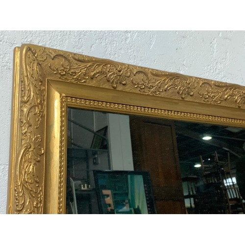 380 - An ornate gilt framed mirror 98 x 72cm