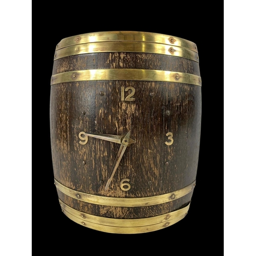 170A - A vintage brass bound wall clock in the style of a barrel. 20 x 26cm.