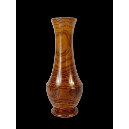 424A - An early 20th century Brazilian Tigerwood vase. 24cm