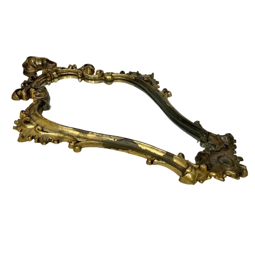 322 - An ornate gilt plastic framed mirror. 48 x 71cm.