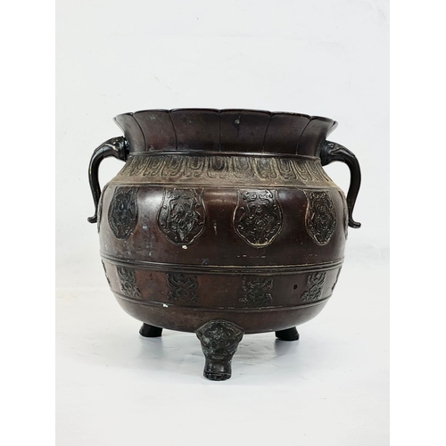 125 - A 19th century Chinese bronze 2 handled pot. 27 x 22cm