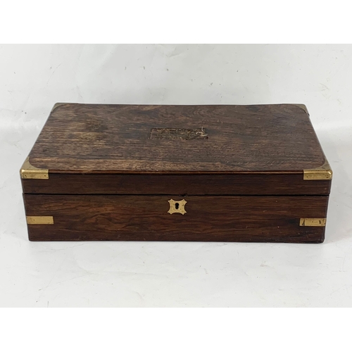 130 - A Victorian rosewood brass bound writing slope, with inkwells, etc. 45x25x13cm