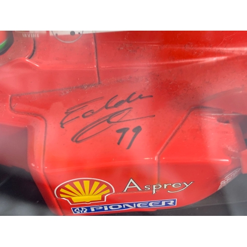 252U - A collection of signed model racing cars by Eddie Irvine. Minichamps model cars and signed Mercedes-... 