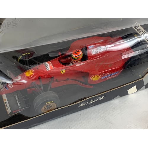 252U - A collection of signed model racing cars by Eddie Irvine. Minichamps model cars and signed Mercedes-... 