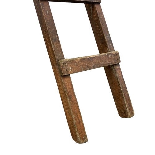 278C - An early 20th century industrial pine ladder in original paint. Polishing Department. 317cm