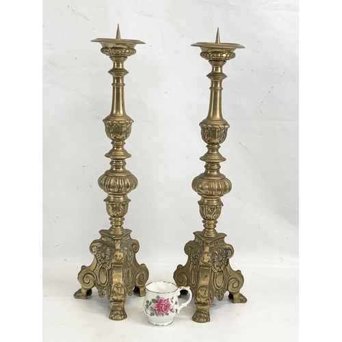 118 - A pair of large ornate brass church candlesticks. 65cm