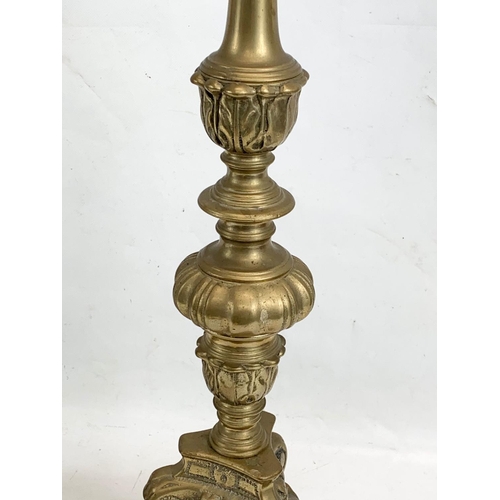 118 - A pair of large ornate brass church candlesticks. 65cm