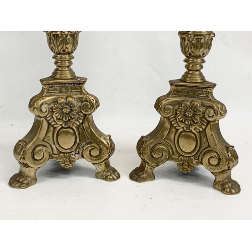 118 - A pair of large ornate brass church candlesticks. 65cm