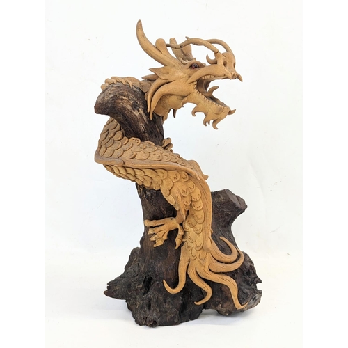 119 - An early 20th century carved wooden Chinese dragon. 35.5cm