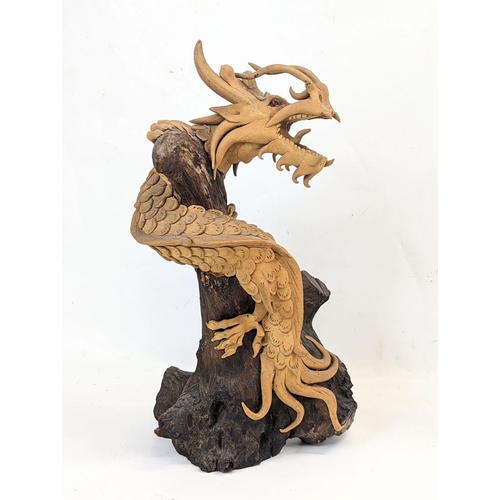 119 - An early 20th century carved wooden Chinese dragon. 35.5cm