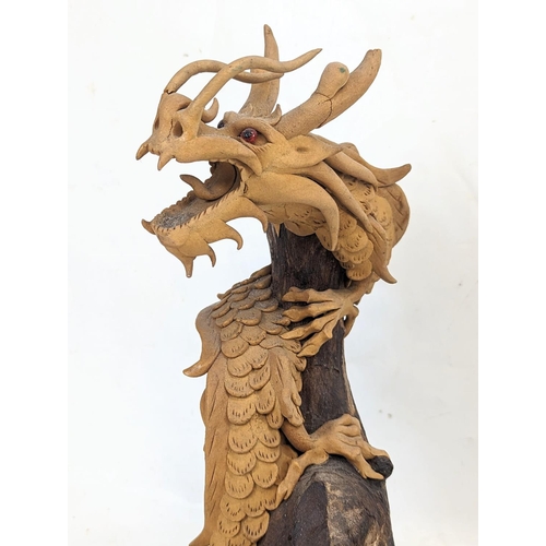 119 - An early 20th century carved wooden Chinese dragon. 35.5cm