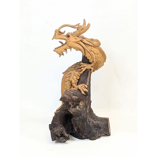 119 - An early 20th century carved wooden Chinese dragon. 35.5cm