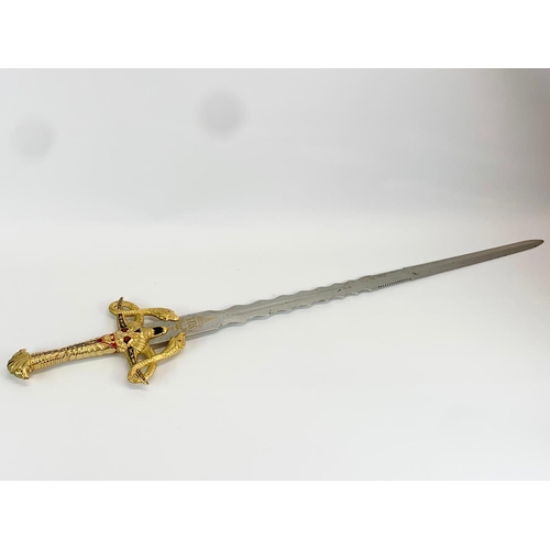 252F - A large decorative steel and brass sword. 119cm