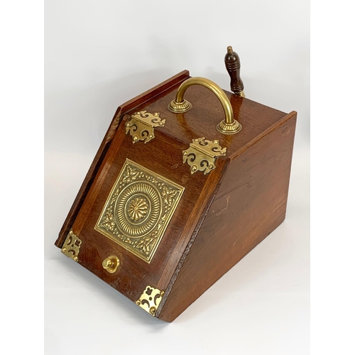 261 - A late Victorian oak and brass coal scuttle. 29 x 42 x 36cm