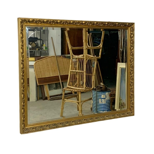 273 - A large ornate gilt framed mirror. 131 x 106cm