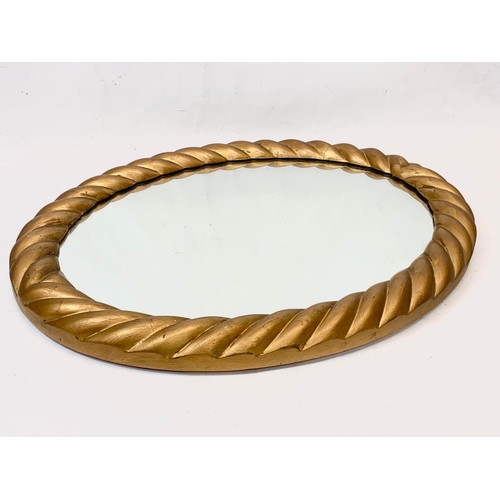 28 - A Victorian gilded rope twist frame mirror. 49 x 62cm