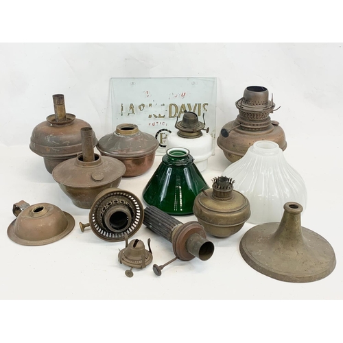 280 - A quantity of Victorian and early 20th century oil lamp parts and glass shades etc.