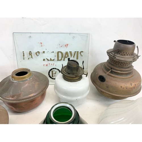 280 - A quantity of Victorian and early 20th century oil lamp parts and glass shades etc.