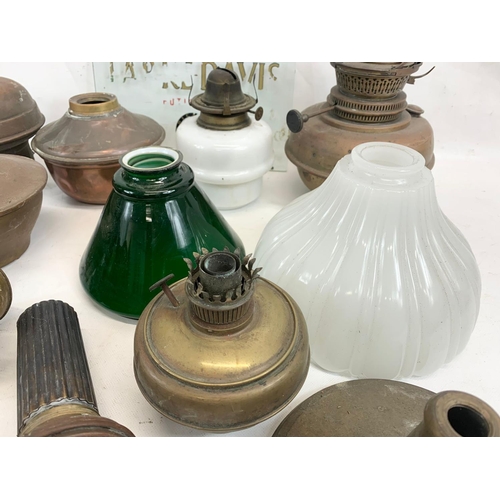 280 - A quantity of Victorian and early 20th century oil lamp parts and glass shades etc.