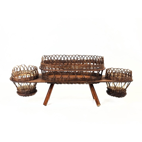 285 - A 1960s bamboo magazine rack with a wicker planter. 47.5x22x50.5cm