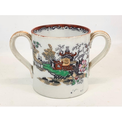 467 - A Victorian pottery loving cup. 22 x 12.5cm.