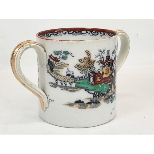 467 - A Victorian pottery loving cup. 22 x 12.5cm.