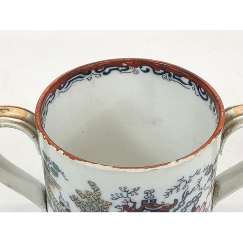 467 - A Victorian pottery loving cup. 22 x 12.5cm.